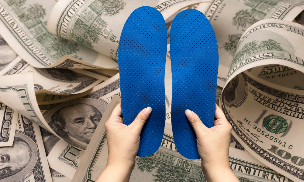 Why are orthotics so expensive? hands holding insoles and money.